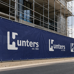 Printed airmesh banner mesh installed across construction scaffolding